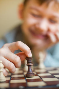 Close-up of boy playing chess