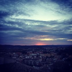 Cityscape against cloudy sky