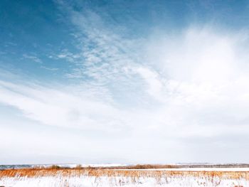 Scenic view of landscape against sky during winter