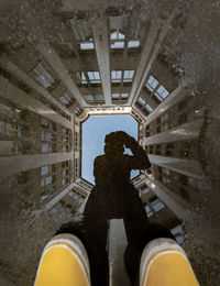 Low section of man standing in building