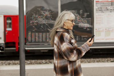 Mature woman at train station