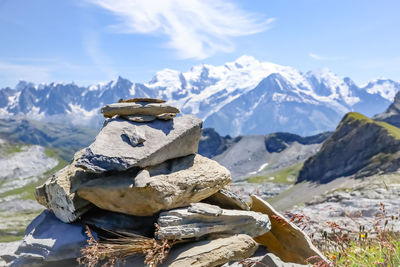 Stack of rocks on mountain against sky