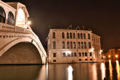 Reflection of illuminated building in water at night