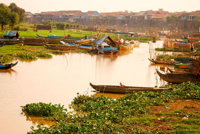 Boats moored at riverbank