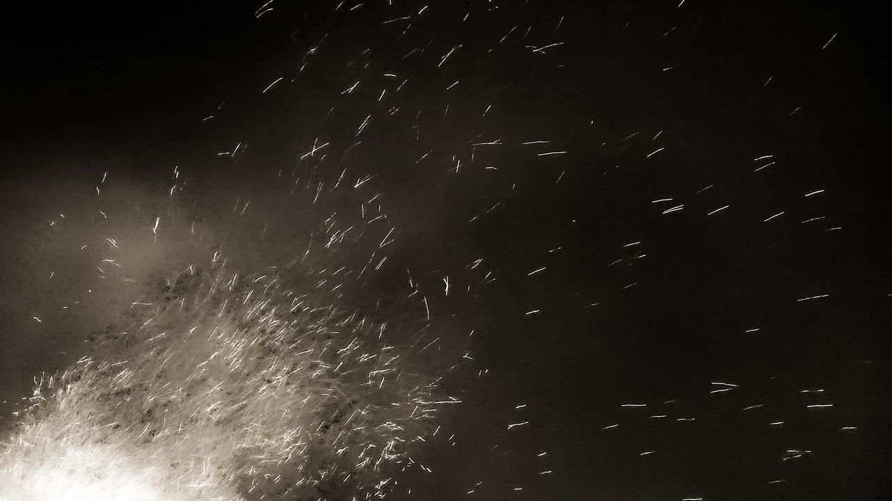 LOW ANGLE VIEW OF FIREWORKS IN SKY