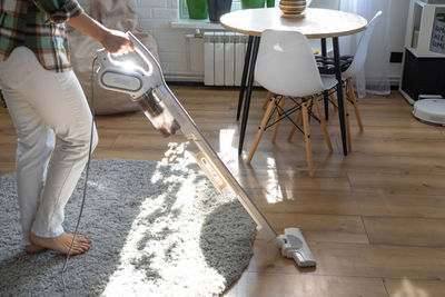 Low section of man standing on hardwood floor