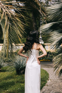 Rear view of woman standing by plants