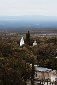View of buildings on mountain against sky
