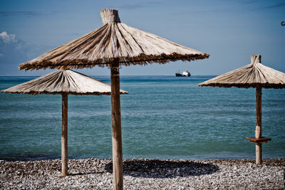 Lifeguard hut on beach against sky