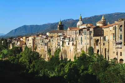 Panoramic view of trees and an italian village against sky
