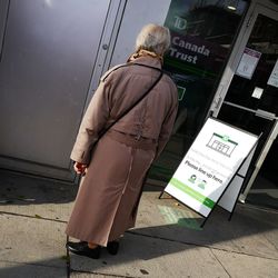 Rear view of woman standing on footpath