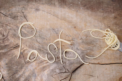 Pasta word on rustic wooden background