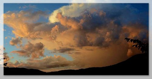 Scenic view of mountains against cloudy sky