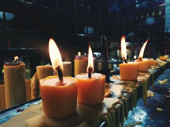 Close-up of lit candles in temple