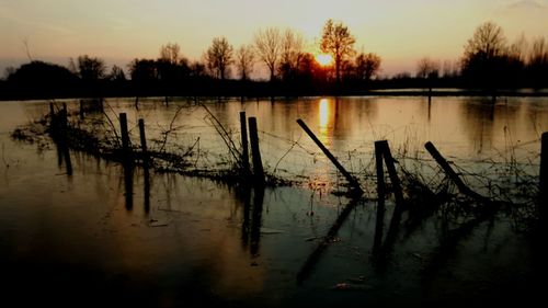 Scenic view of lake against sky during sunset