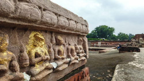 Statue of historic temple against sky