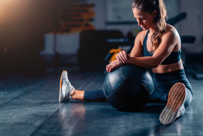 Side view of woman exercising in gym
