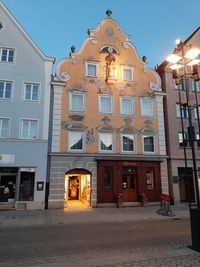 Low angle view of illuminated building against sky