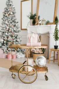 A transfer cart with christmas decor and gifts in the interior of a classic living room