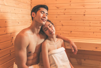 Young couple sitting in sauna