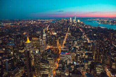 High angle view of city lit up at night