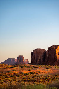 Rock formations on landscape against clear sky