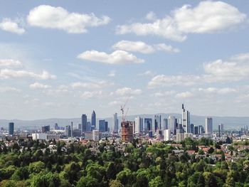 Skyscrapers against cloudy sky