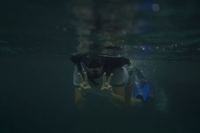 Young woman swimming underwater