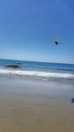 Scenic view of sea against blue sky