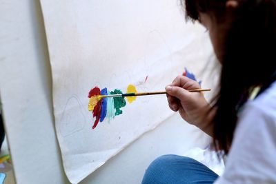 Midsection of woman holding umbrella