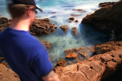 Rear view of man at sea shore