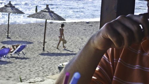 Low section of people relaxing on beach