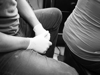 Low section of woman sitting in train