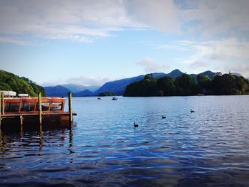 Scenic view of calm lake against mountain range