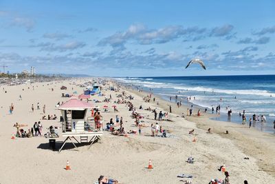 High angle view of people at beach against sky