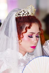 Close-up of woman with hand holding dress