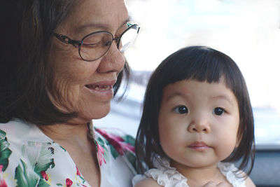 Woman with grandchild in car