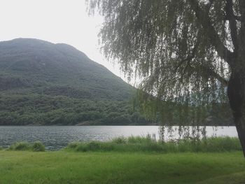 Scenic view of lake by mountains against sky