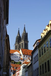 Low angle view of buildings in city against clear sky