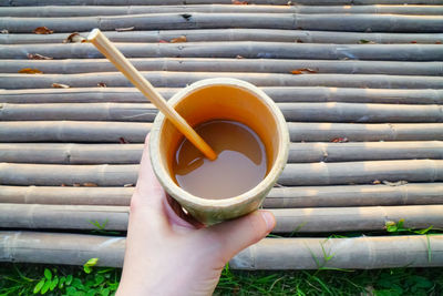 Cropped image of hand holding coffee cup