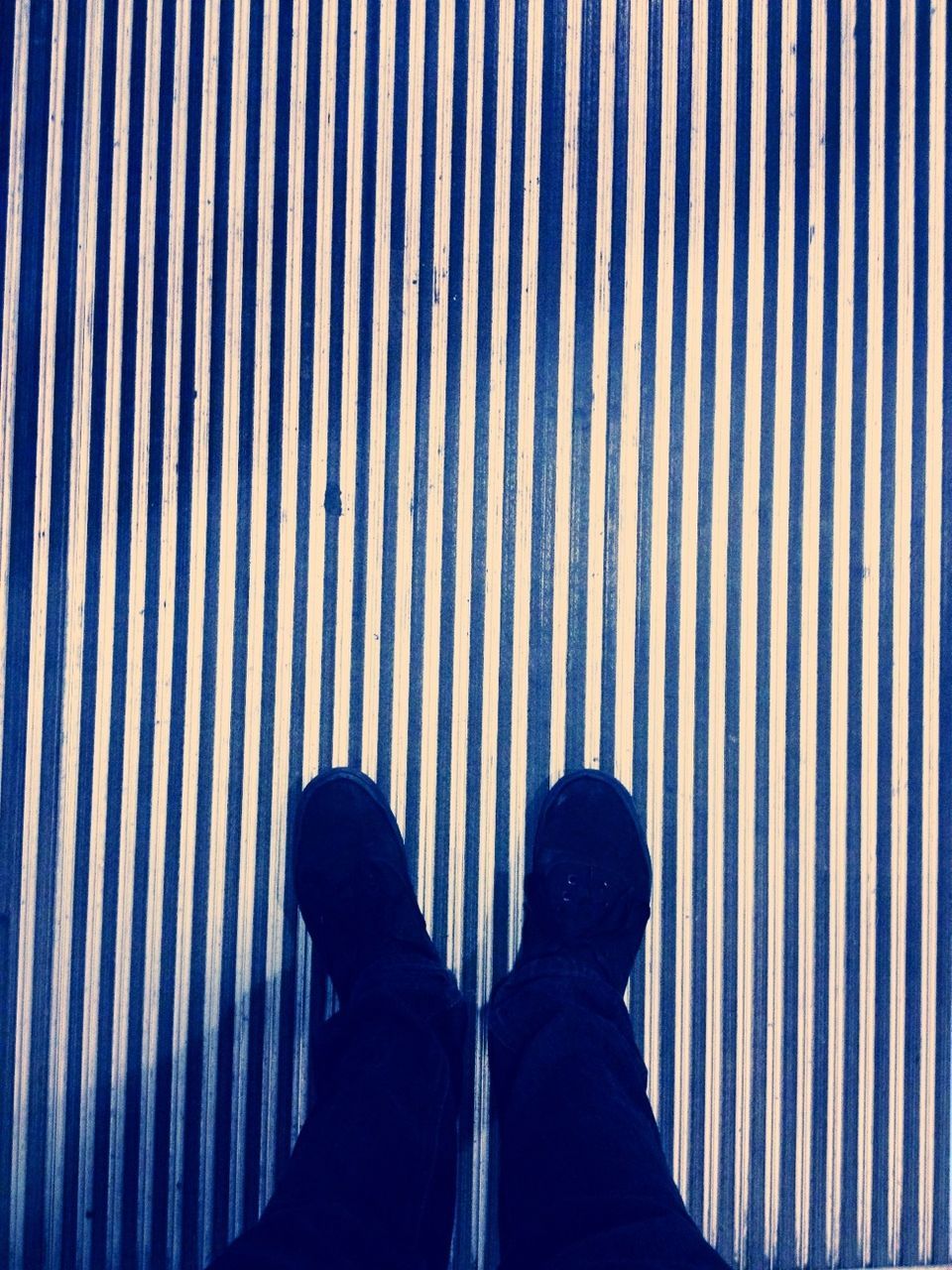 low section, person, standing, pattern, personal perspective, shoe, lifestyles, men, unrecognizable person, human foot, striped, leisure activity, blue, high angle view, indoors, footwear