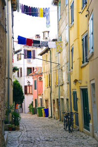 Narrow street amidst buildings in city