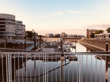 High angle view of buildings by river against sky