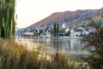 Scenic view of lake by buildings against sky