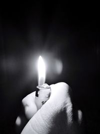 Close-up of hand holding candle