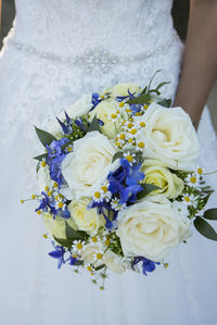Midsection of woman holding flower bouquet