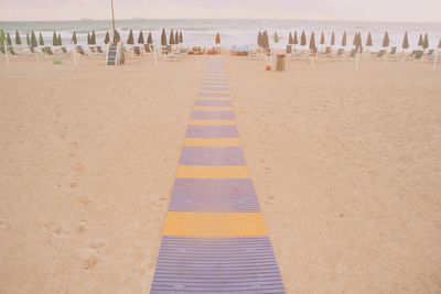 Row of deck chairs on beach
