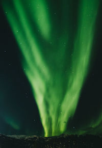Low angle view of illuminated lights against sky at night