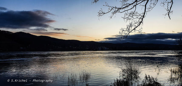 Scenic view of lake against sky during sunset