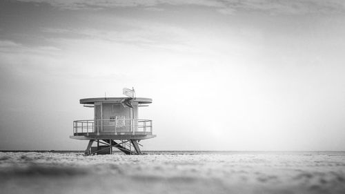 Lifeguard hut on beach against sky